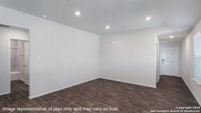 spare room with visible vents, baseboards, dark wood finished floors, and recessed lighting