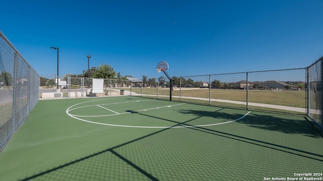 view of basketball court with community basketball court and fence