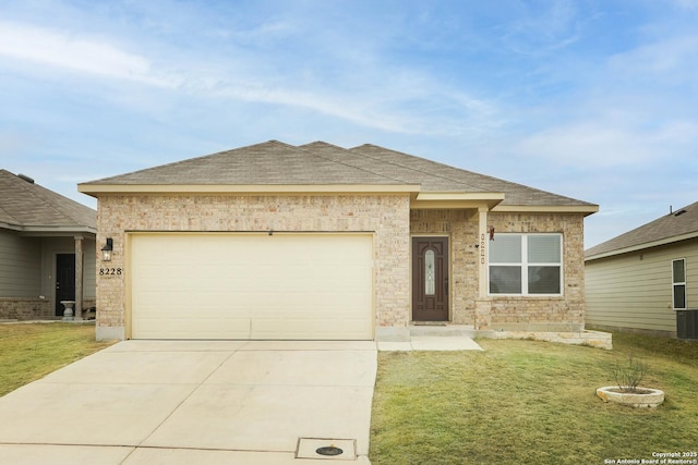 ranch-style home with a front yard, concrete driveway, roof with shingles, and an attached garage