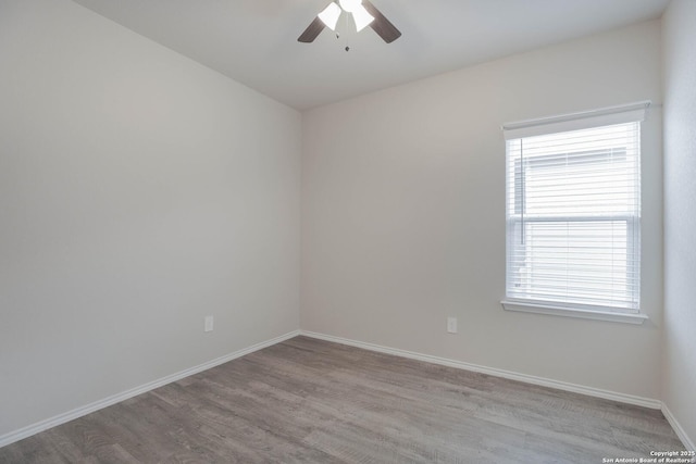 empty room with light wood finished floors, ceiling fan, and baseboards