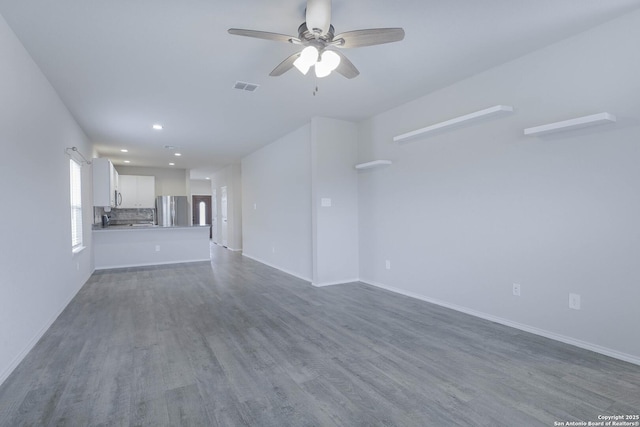 unfurnished living room featuring recessed lighting, visible vents, dark wood-type flooring, ceiling fan, and baseboards