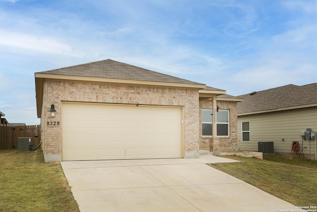 view of front of home featuring a garage, driveway, central AC unit, and a front yard