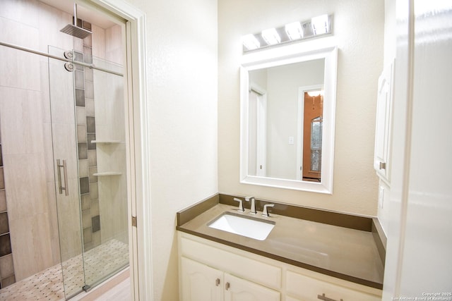 full bathroom featuring a shower stall and vanity