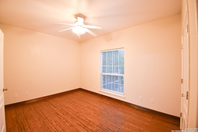 empty room with a ceiling fan, baseboards, and wood finished floors