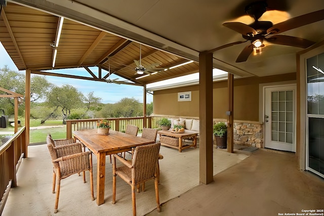 view of patio / terrace with an outdoor living space, a ceiling fan, and outdoor dining space