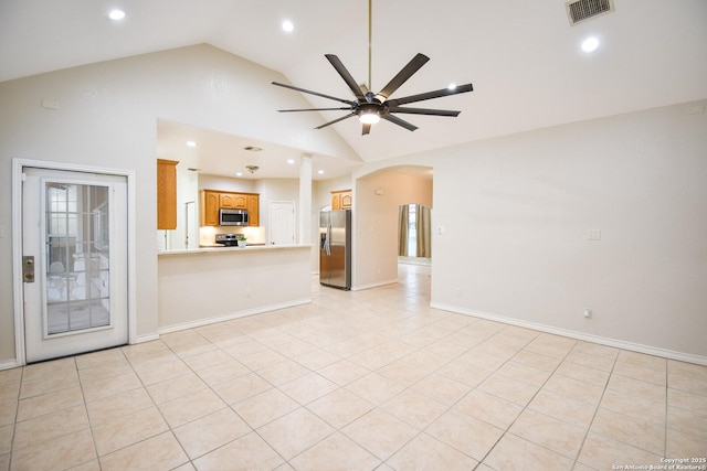 unfurnished living room with a ceiling fan, arched walkways, visible vents, and light tile patterned floors