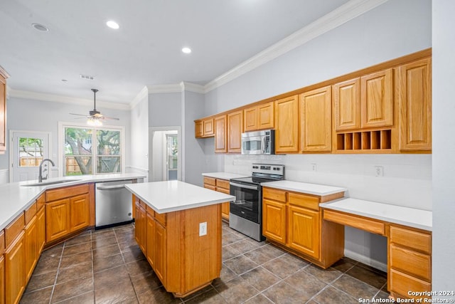 kitchen featuring stainless steel appliances, a sink, light countertops, and a center island