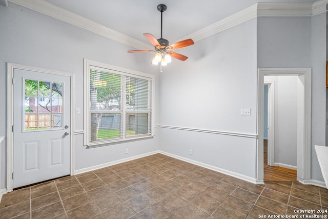 entryway featuring baseboards, a ceiling fan, and crown molding