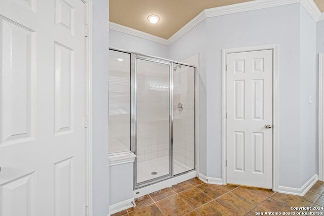 full bathroom with baseboards, tile patterned flooring, a shower stall, and crown molding