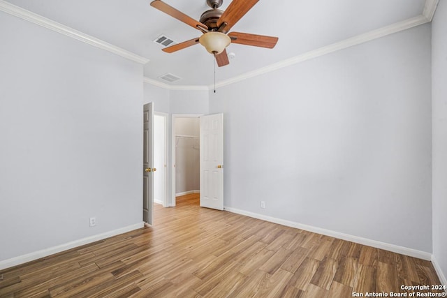 unfurnished room with baseboards, ornamental molding, and wood finished floors