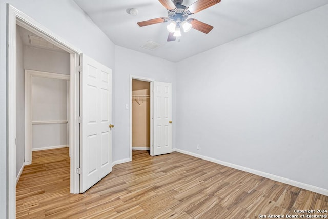 unfurnished bedroom featuring a closet, baseboards, ceiling fan, and light wood finished floors