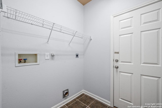 laundry room featuring laundry area, baseboards, dark tile patterned flooring, hookup for a washing machine, and hookup for an electric dryer