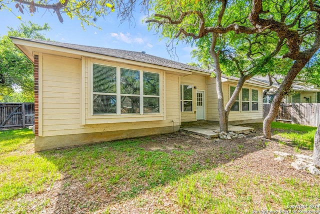 rear view of house with fence