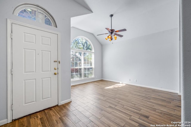 entrance foyer with baseboards, a ceiling fan, vaulted ceiling, and wood finished floors