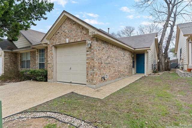 view of front of property with a garage, driveway, brick siding, and a front lawn