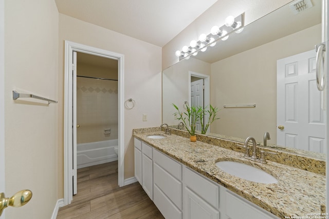 bathroom featuring visible vents, a sink, toilet, and wood finished floors