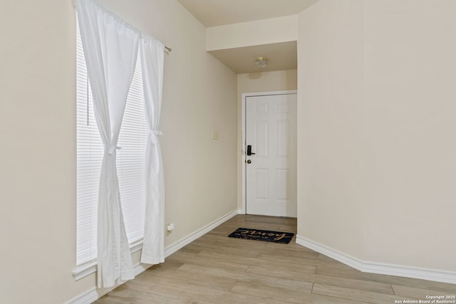 interior space with light wood-type flooring and baseboards