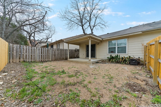 back of house featuring a patio area and a fenced backyard