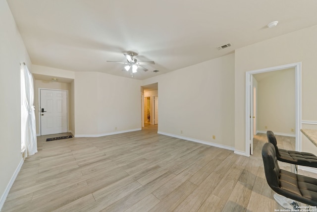 unfurnished office featuring light wood finished floors, baseboards, visible vents, and ceiling fan