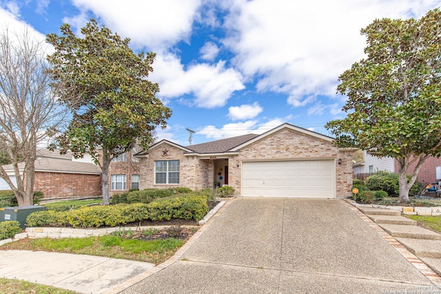 ranch-style house with brick siding, an attached garage, and concrete driveway