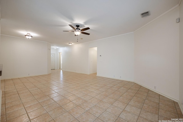 spare room featuring visible vents, ornamental molding, light tile patterned flooring, baseboards, and ceiling fan