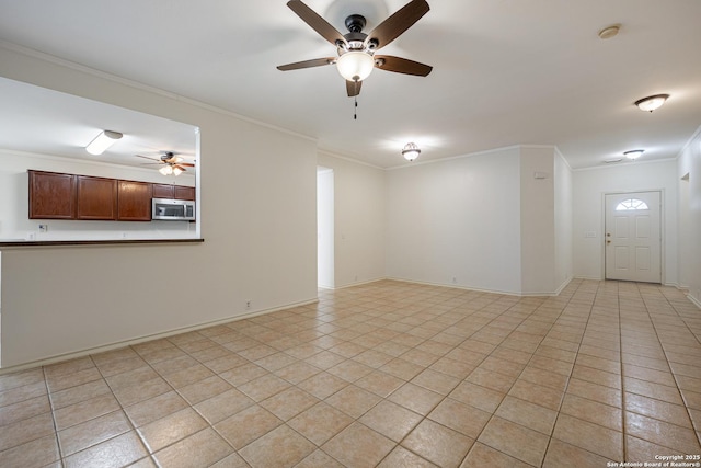 unfurnished living room with light tile patterned floors, baseboards, and crown molding