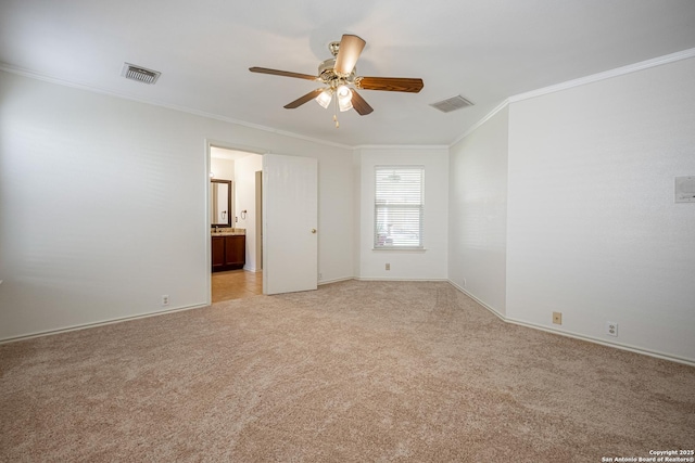 spare room with visible vents, light colored carpet, ceiling fan, and ornamental molding