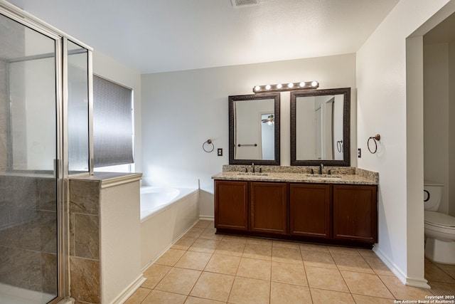 full bath with a sink, toilet, a bath, and a shower stall