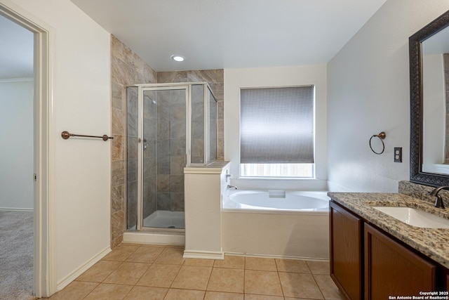 bathroom with a garden tub, a stall shower, vanity, and tile patterned flooring