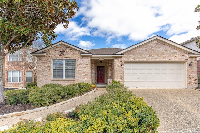 single story home with an attached garage, brick siding, driveway, and roof with shingles