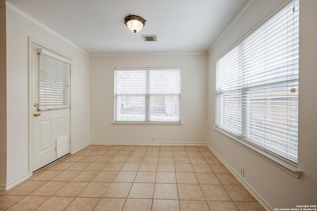 unfurnished room with light tile patterned floors, visible vents, baseboards, and ornamental molding