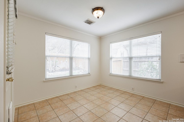 unfurnished room with crown molding, light tile patterned floors, baseboards, and visible vents