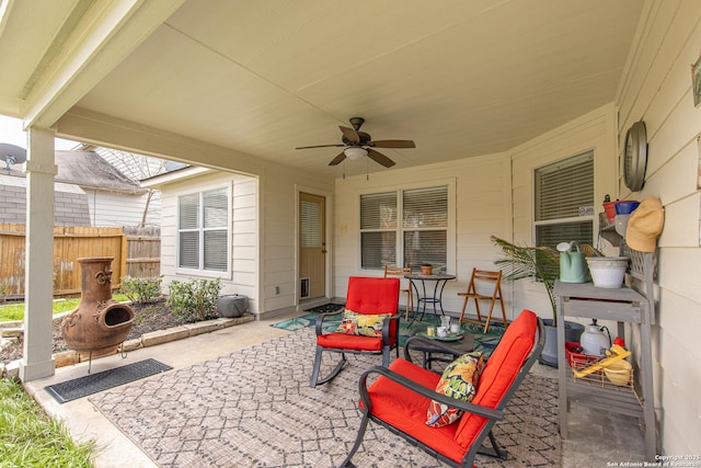 view of patio / terrace with ceiling fan and fence