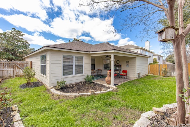 back of house with a patio area, a fenced backyard, a lawn, and a ceiling fan