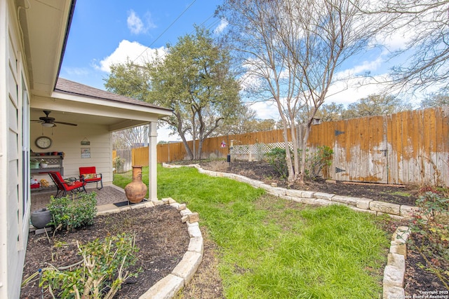 view of yard with a patio area, a ceiling fan, and a fenced backyard