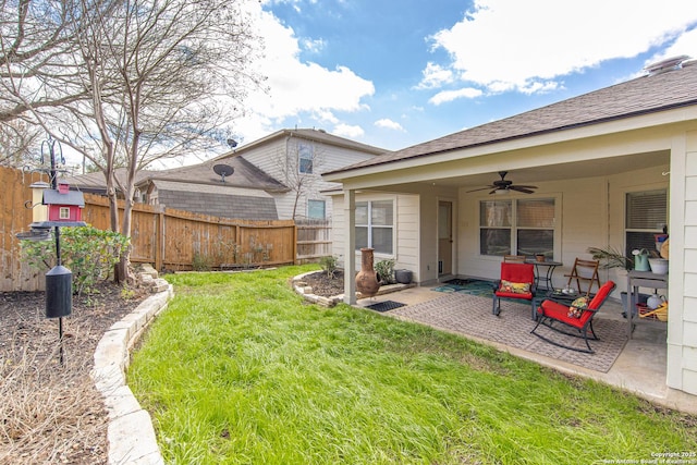 view of yard featuring a patio, ceiling fan, and fence