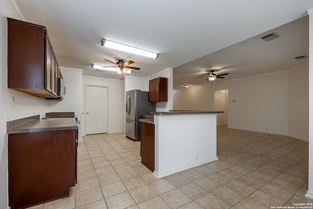 kitchen featuring visible vents, dark countertops, appliances with stainless steel finishes, and ceiling fan