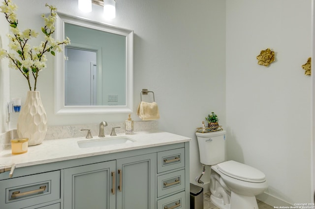 half bathroom featuring toilet and vanity