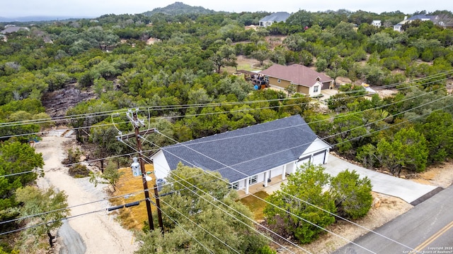 drone / aerial view with a view of trees