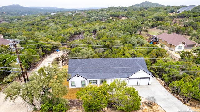 drone / aerial view featuring a forest view