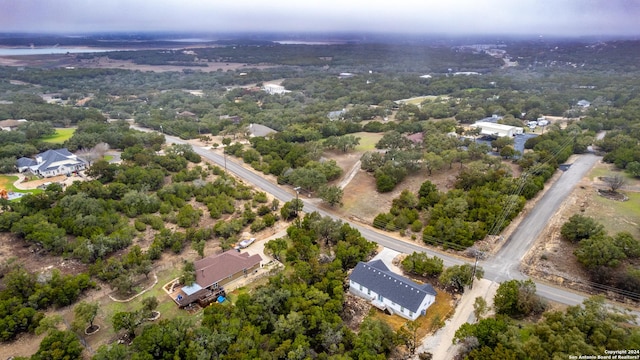 birds eye view of property featuring a forest view