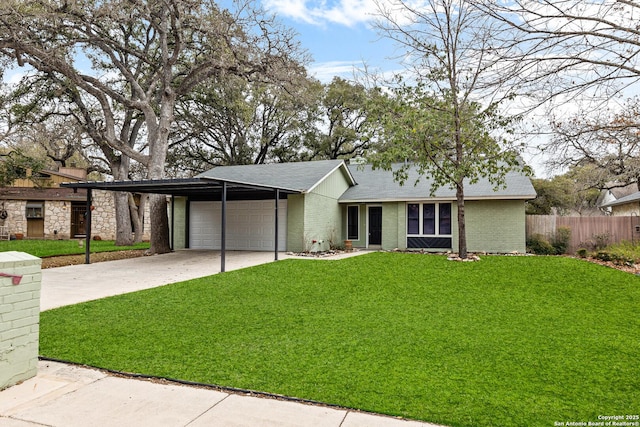 view of front facade with a carport, a front yard, and brick siding