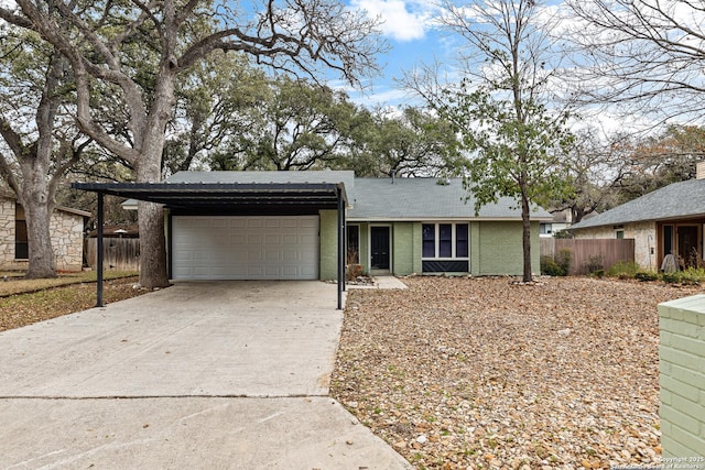 ranch-style home featuring a garage, concrete driveway, brick siding, and fence