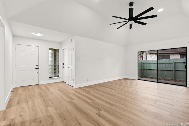 interior space featuring plenty of natural light, vaulted ceiling, and light wood finished floors