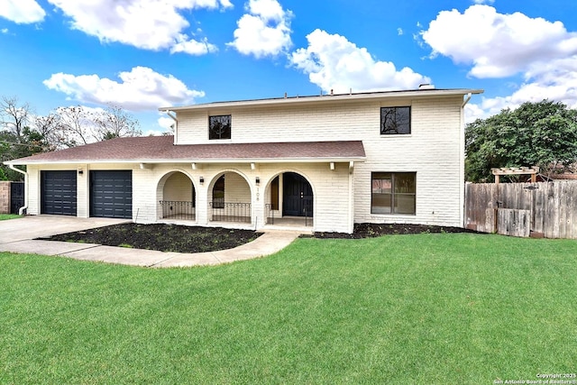 view of front facade with an attached garage, concrete driveway, and a front yard