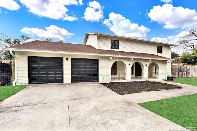 view of front of home featuring driveway, an attached garage, fence, a porch, and brick siding