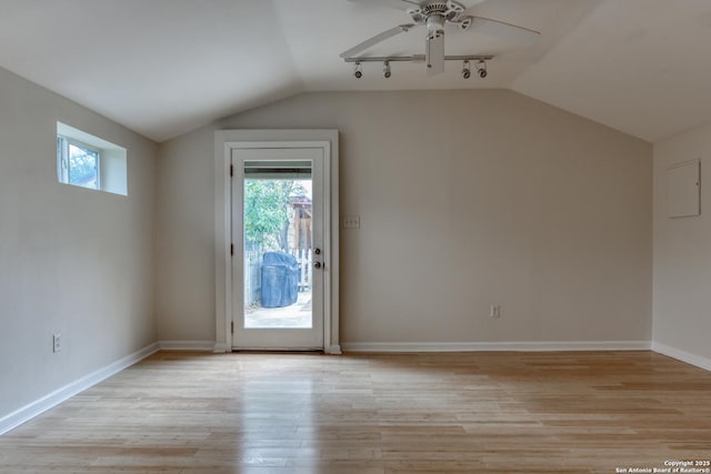 additional living space featuring lofted ceiling, light wood-style flooring, baseboards, and ceiling fan