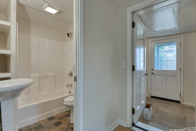 full bathroom featuring baseboards, tub / shower combination, a sink, and toilet