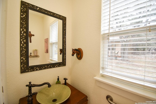 bathroom featuring a textured wall