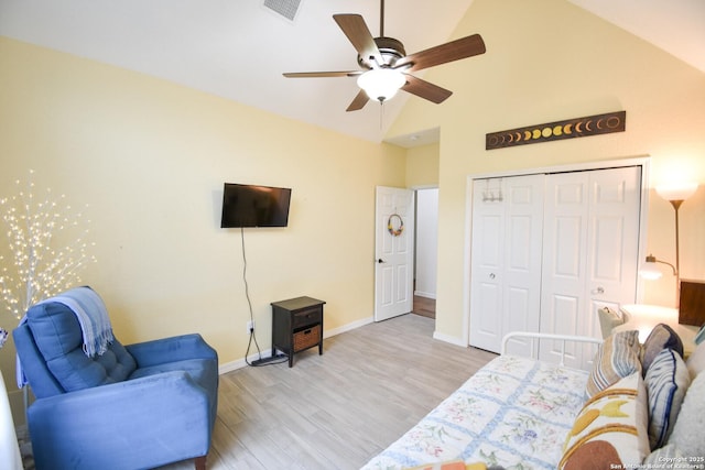 living area featuring ceiling fan, high vaulted ceiling, visible vents, baseboards, and light wood finished floors